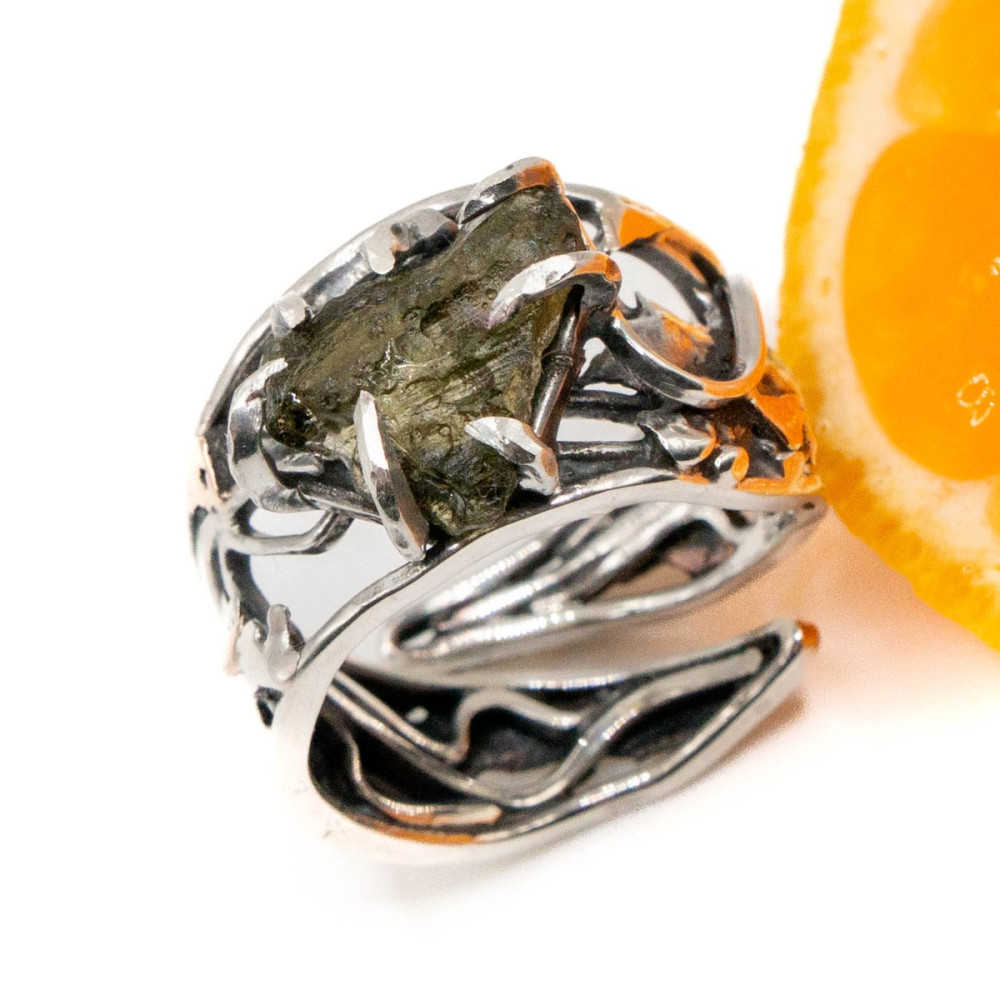 Silver ring with gold and untreated moldavite in an openwork frame